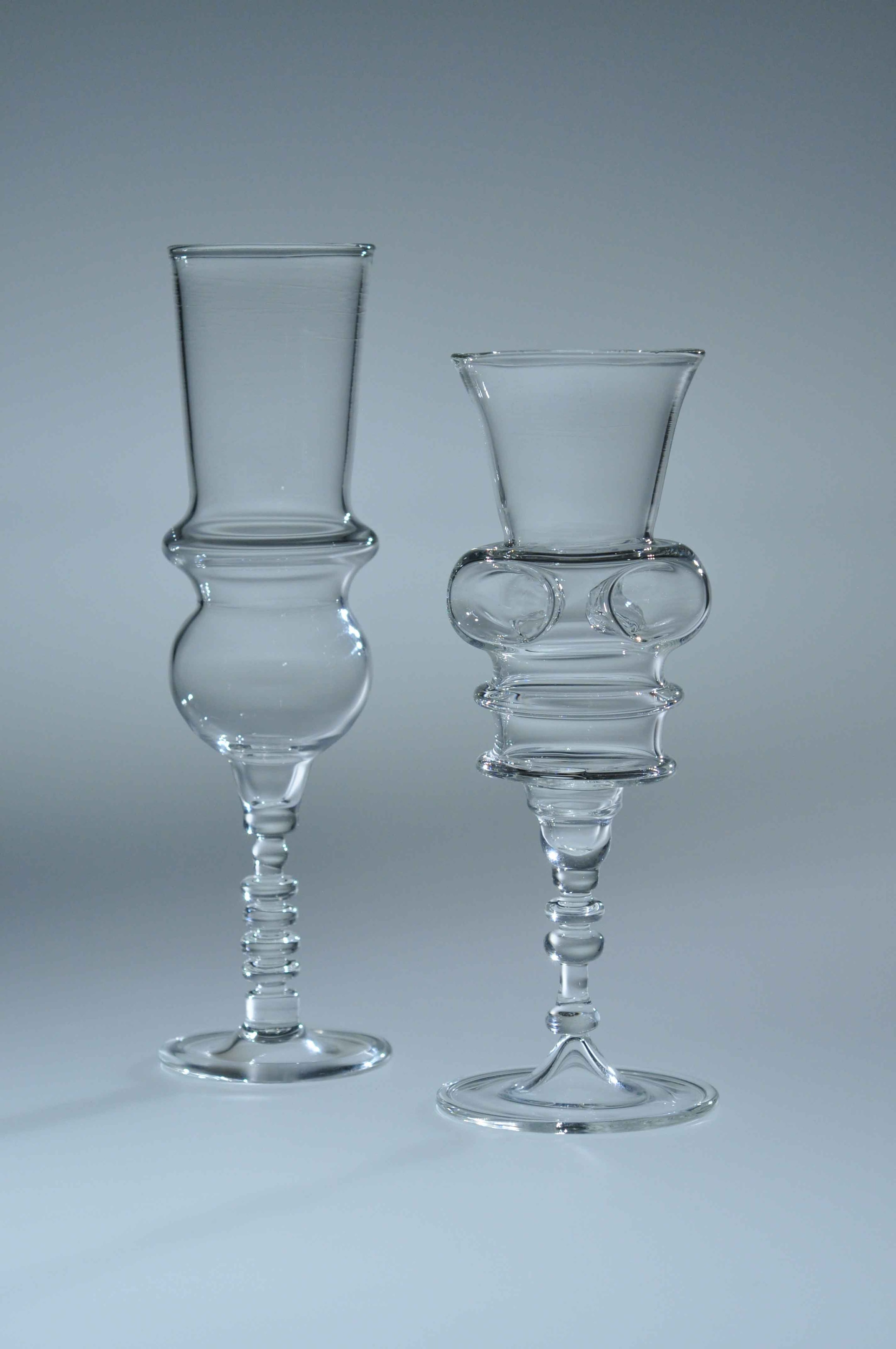 Two clear borosilicate goblets — tall sculptural stems with ornate ring and bubble details